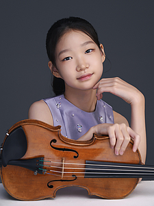 The picture shows a child with a violin.