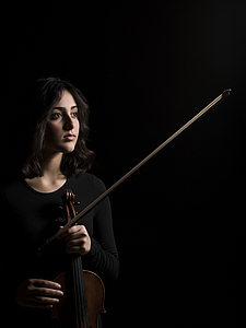 The picture shows a young person with a violin.