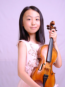 The picture shows a child with a violin.
