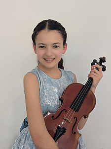 The picture shows a child with a violin.