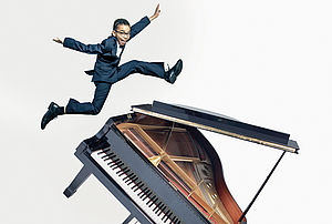 The picture shows a young man jumping over a grand piano. 