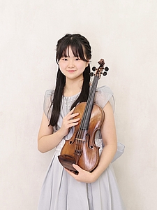 The picture shows a child with a violin.