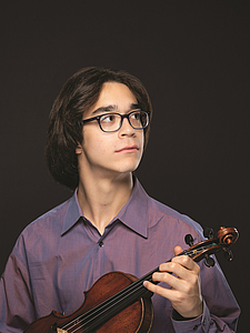 The picture shows a young person with a violin.