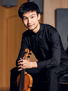 The picture shows a young person with a violin.