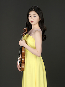 The picture shows a child with a violin.