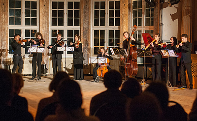 The picture shows students on a stage.