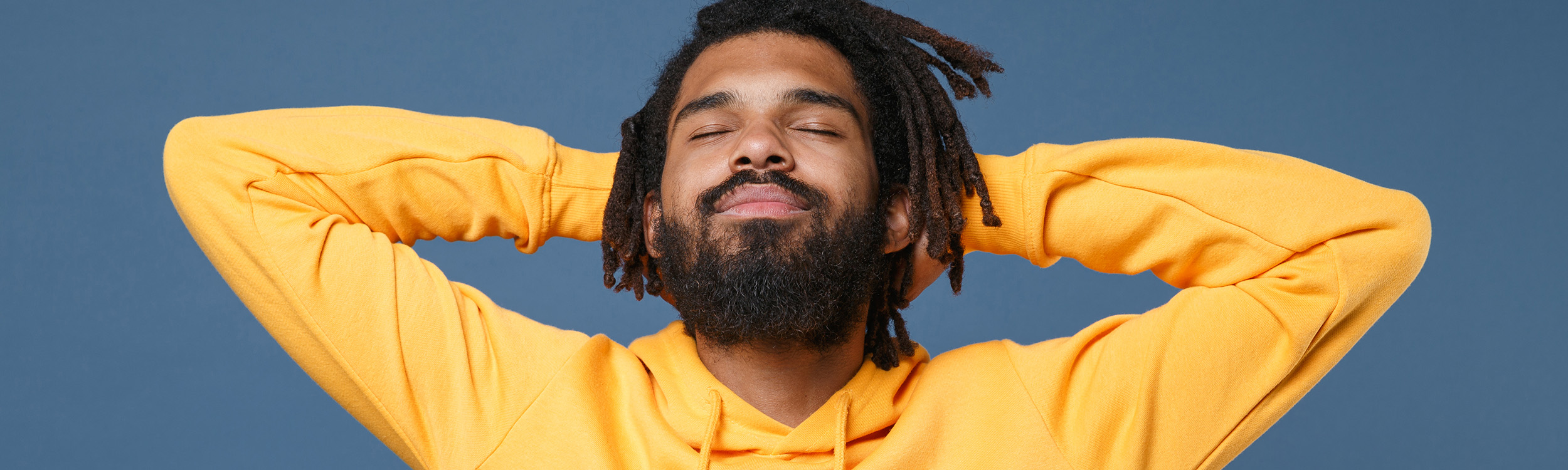 The picture shows a man in a yellow jumper.