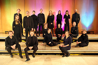 The picture shows students on a stage.