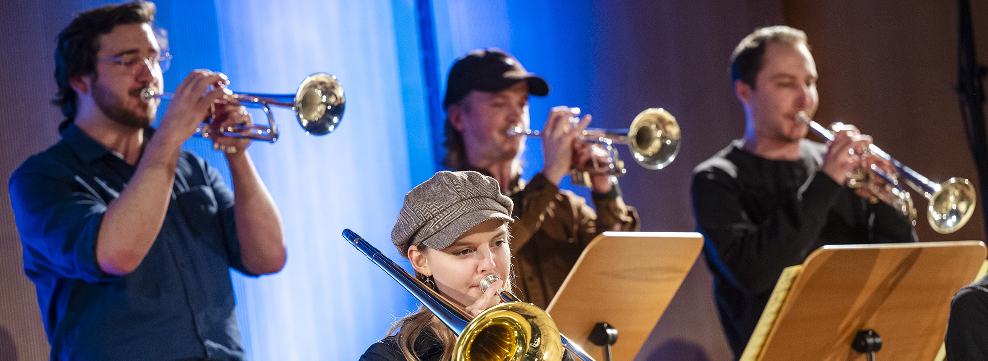 The image shows musicians on a stage.