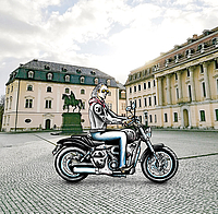 The graphic shows a man on a motorcycle.