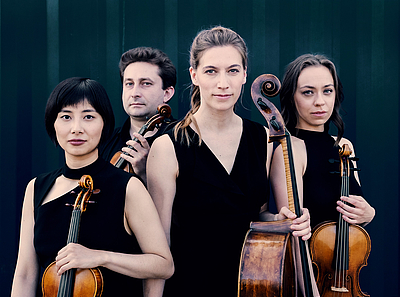 The picture shows four musicians.