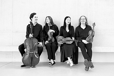 The picture shows four musicians.