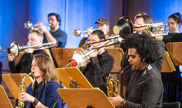 Das Foto zeigt junge Menschen mit Blasinstrumenten.