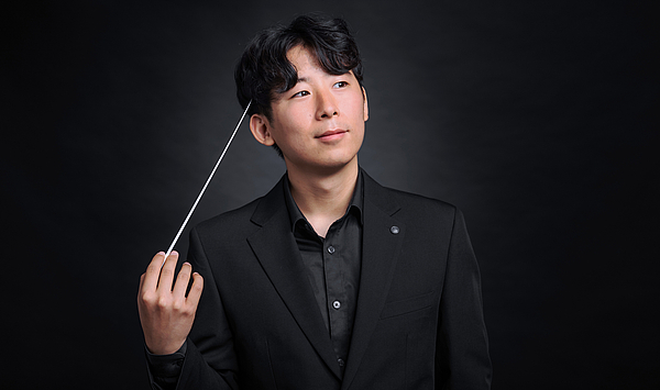 The picture shows a man with a baton.