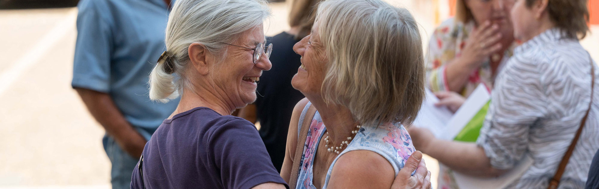 The picture shows two women looking at each other.